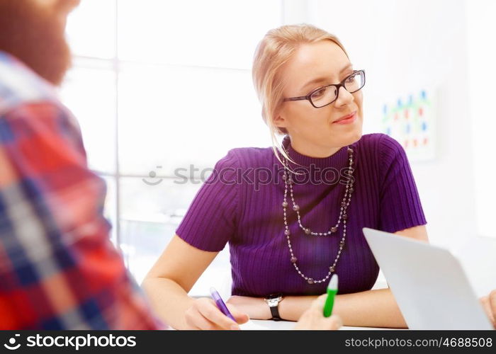 Business woman in office. Young and pretty business woman working in office