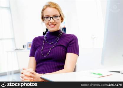 Business woman in office. Young and pretty business woman working in office