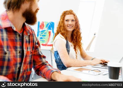 Business woman in office. Young and pretty business woman working in office