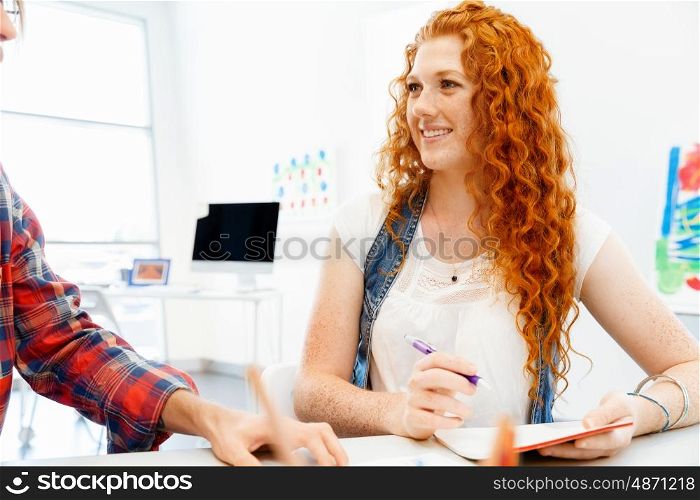 Business woman in office. Young and pretty business woman working in office