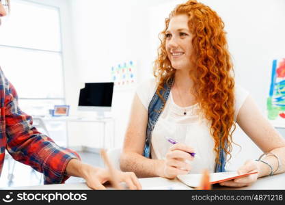 Business woman in office. Young and pretty business woman working in office