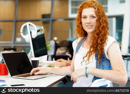 Business woman in office. Young and pretty business woman working in office