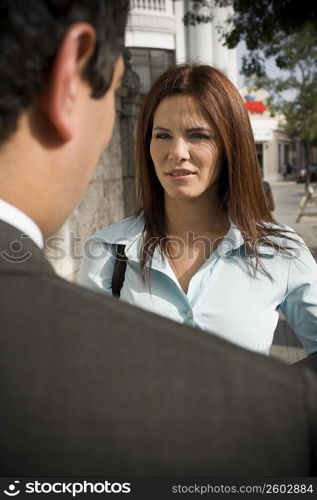 Business woman interacting with business man, outdoors