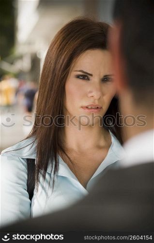 Business woman interacting with business man, outdoors