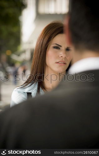 Business woman interacting with business man, outdoors