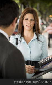 Business woman interacting with business man, outdoors