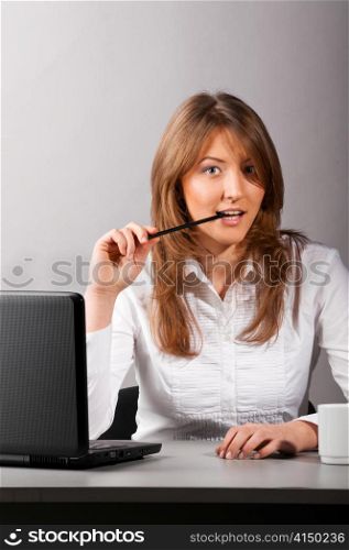 business woman is sitting in the office with laptop and flirting