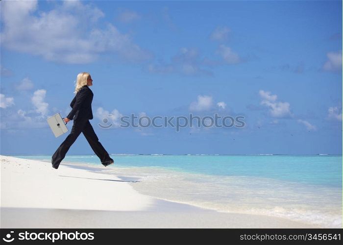 business woman jump in ocean waves