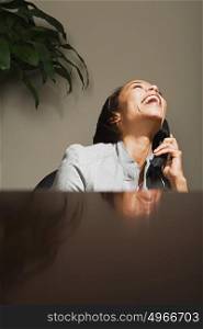 Business woman laughing on the telephone