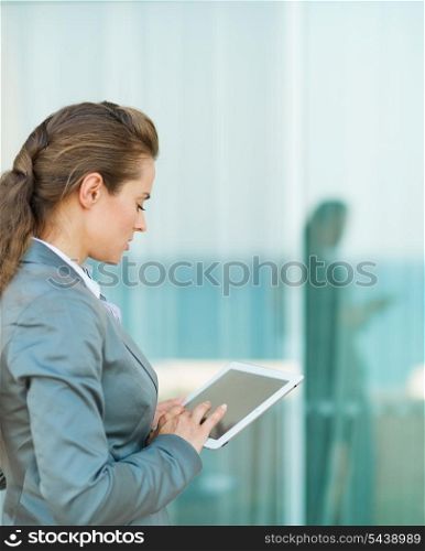 Business woman looking in tablet PC
