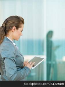Business woman looking in tablet PC
