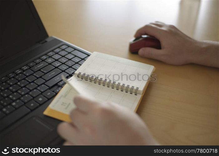 Business woman making appointment on notebook
