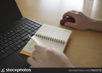 Business woman making appointment on notebook