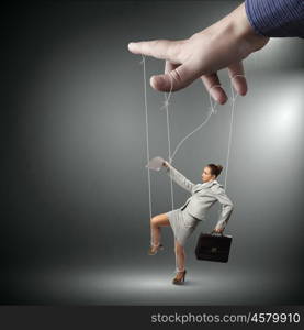 Business woman marionette. Businesswoman marionette on ropes with suitcase in hand