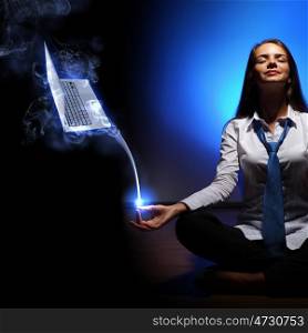 Business woman meditating. Young business woman sitting in asana lotus and meditating