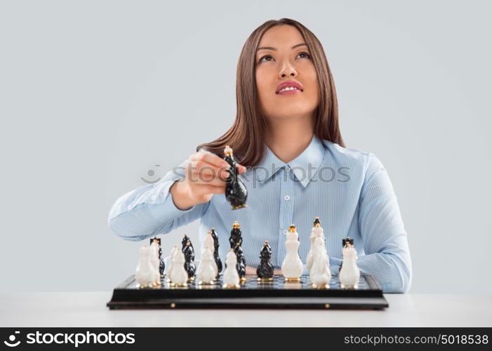 Business woman moving chess figure - strategy or leadership concept