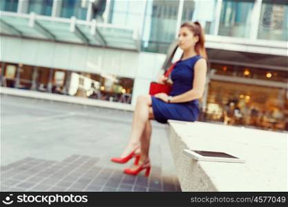 Business woman on background with a smart phone. A smart phone with a business womansitting on background