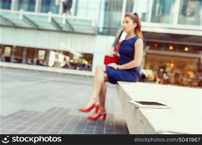Business woman on background with a smart phone. A smart phone with a business womansitting on background