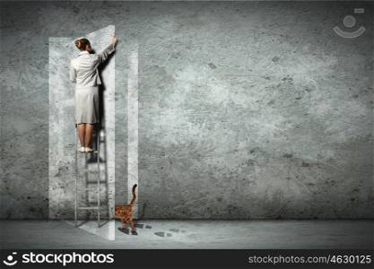 Business woman on ladder. Businesswoman standing on ladder opening visional door