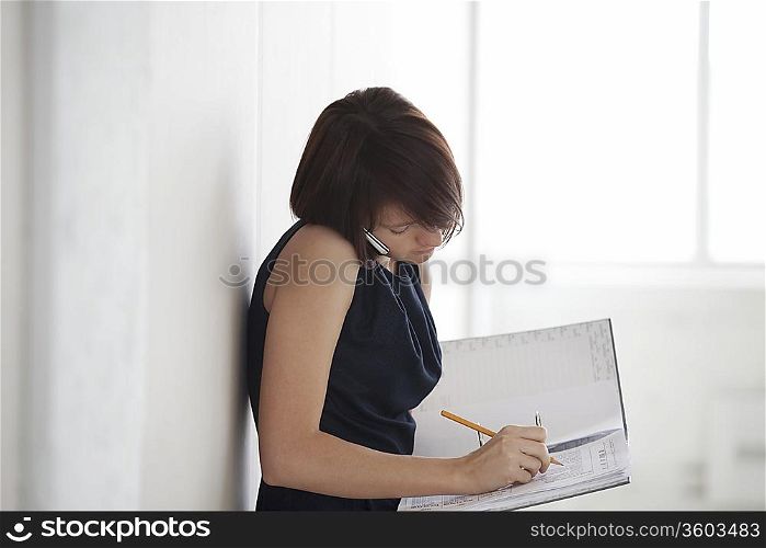 Business woman on making notes in empty warehouse