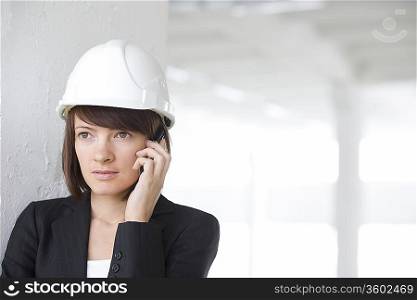 Business woman on mobile phone in empty warehouse