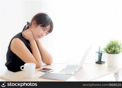 Business woman overwork on laptop computer and neck pain with at work in office, girl stress and illness chronic with office syndrome, health and emotion concept.