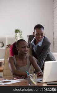 Business Woman pointing at laptop for her colleague