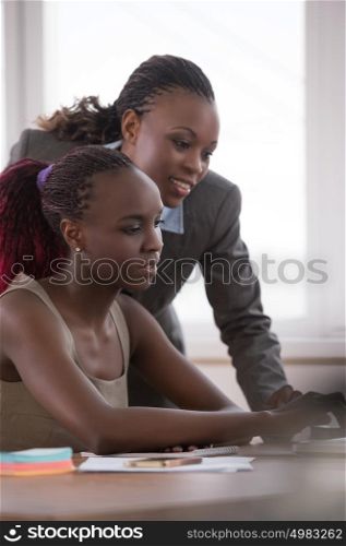 Business Woman pointing at laptop for her colleague