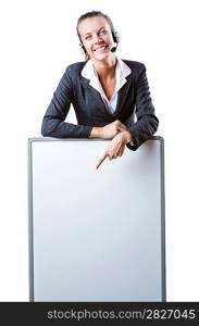 Business woman pointing at white board and smiling.