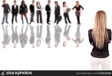 Business woman posing backwards with group of people in the back