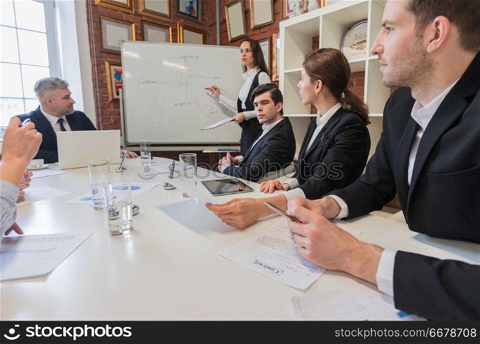Business woman presenting teamwork concept on flipchart at office meeting. Business woman presenting teamwork concept