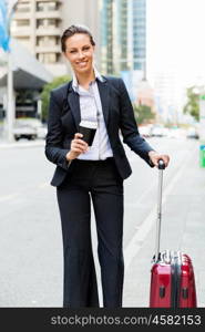 Business woman pulling suitcase walking in city. Young business woman pulling suitcase walking in urban city