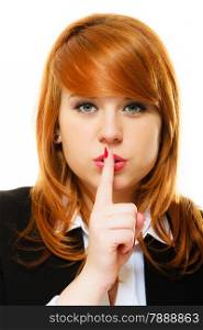 Business woman redhaired girl asking for silence or secrecy with finger on lips hush hand gesture. Isolated