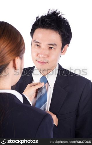 business woman's hands adjusting neck tie of man in suit isolated on white background