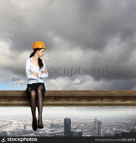 Business woman sitting high over a cityscape