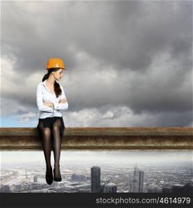 Business woman sitting high over a cityscape