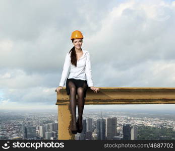 Business woman sitting high over a cityscape