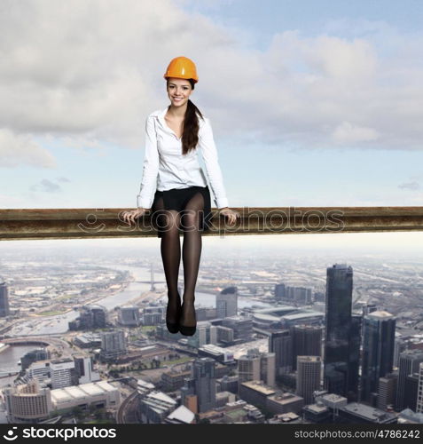 Business woman sitting high over a cityscape