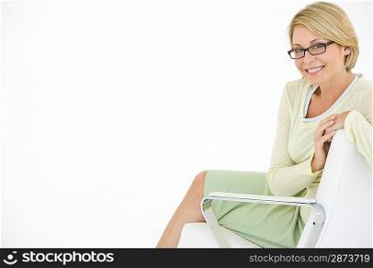 Business woman sitting in chair, portrait