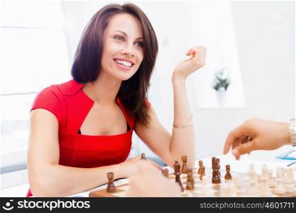 Business woman sitting in front of chess and planning. Business woman sitting in front of chess