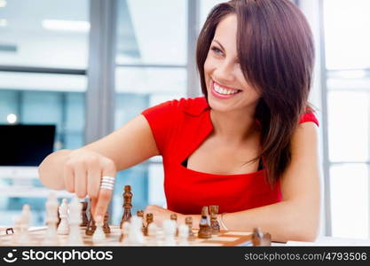 Business woman sitting in front of chess and planning. Business woman sitting in front of chess