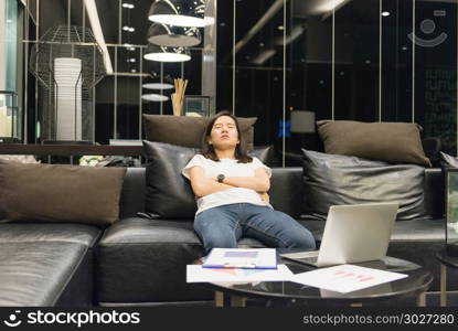 business woman sleeping on sofa in living room at night