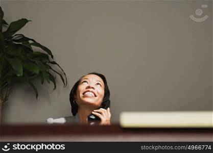Business woman smiling on the telephone