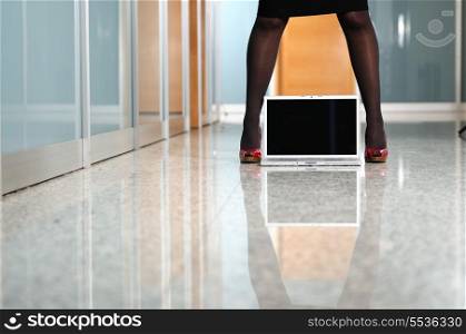business woman stand with shoe on modern laptop