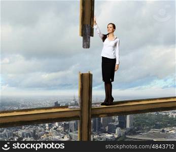 Business woman standing high over a cityscape