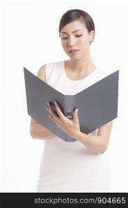 Business woman standing, holding file and waring white dress on white background