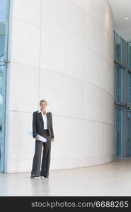 business woman standing outside building