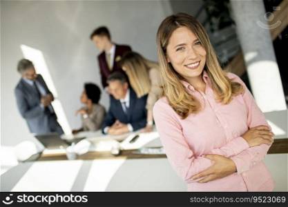Business woman standing with her staff have a meeting in the background