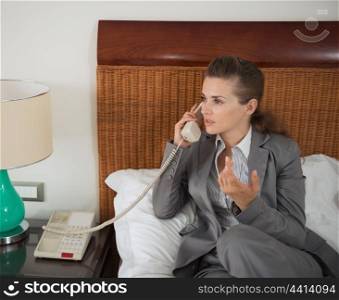 Business woman talking phone in hotel room