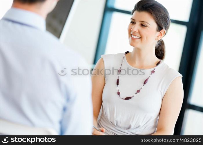 Business woman talking to her collegues in office
